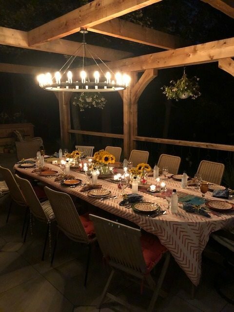 table with chandelier on patio