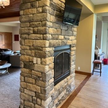 a stone fireplace with mantel