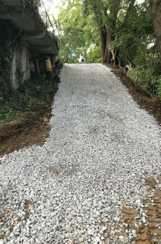 gravel starting to cover dirt pathway under patio