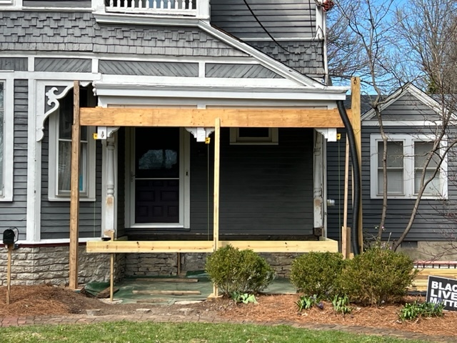 Wooden frame being built around Victorian porch