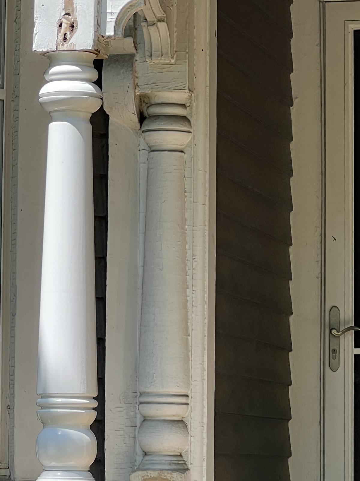 Peeling paint on old porch spindles