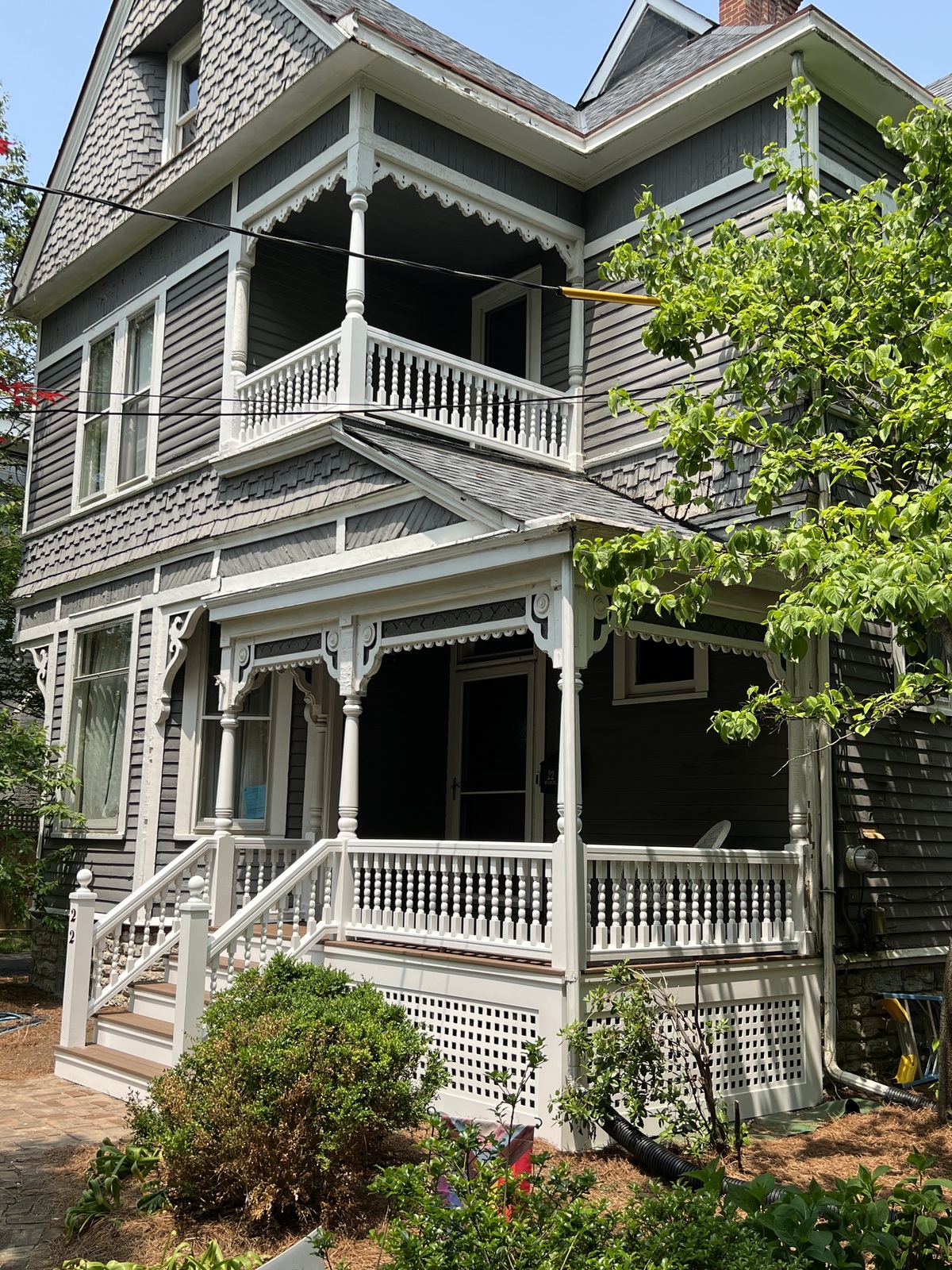 Gray Victorian house with a double porch