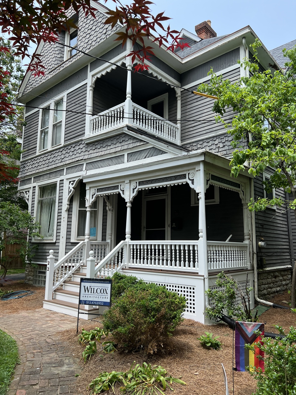 Gray Victorian house with a restored white porch