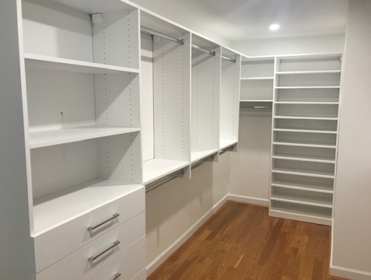 White closet shelving with drawers