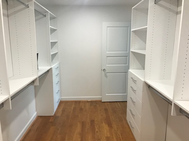 White wood closet shelving with drawers