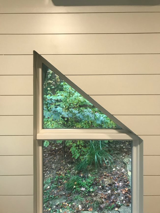 half triangle and square window showing woods 