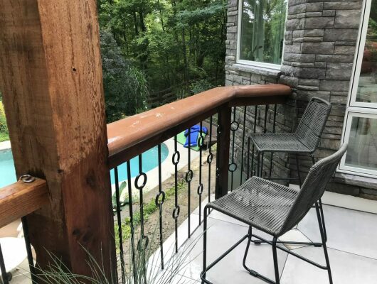 railing with chairs and pool in background