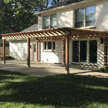 wooden patio overhang attached to house