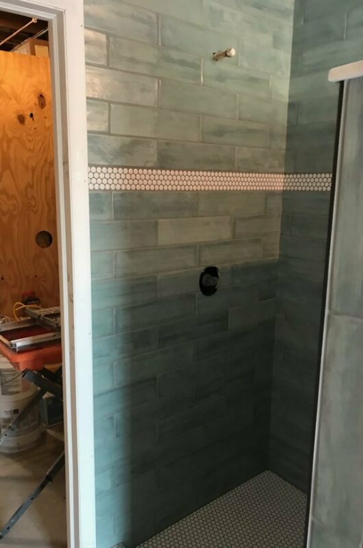 shower with blue and white tile