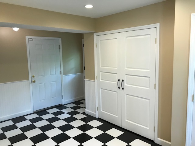 black and white tile room with doors