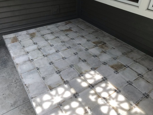 gray tile patio with blue flower design