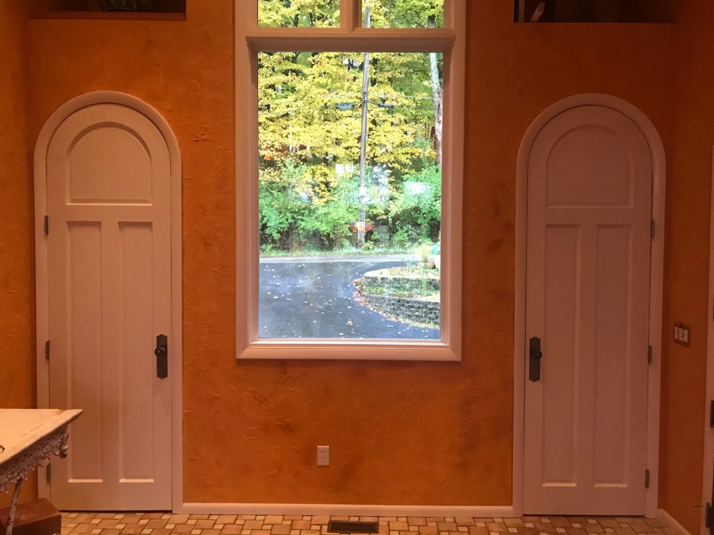 white rounded doors installed with orange lighting