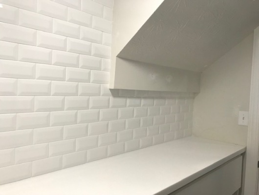 white brick backsplash and cabinets