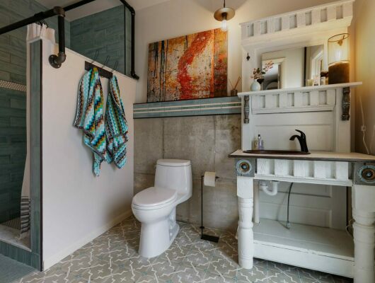 custom bathroom with shower, toilet, and sink
