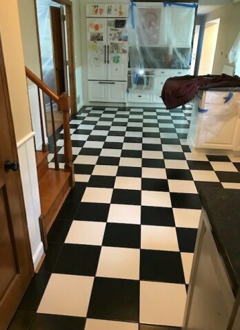 black and white floor tile with counter and stairs