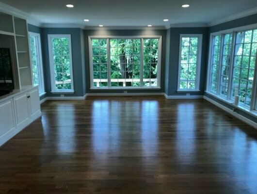 room with hardwood floors and lots of windows