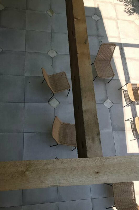 above view of patio with gray tile and chairs
